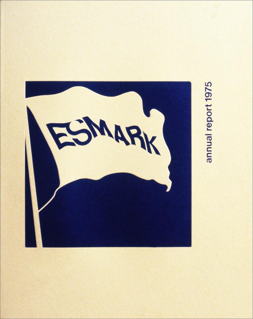Flag-shaped logo with the word "ESMARK" on a blue background and "annual report 1975" in small text on the side.