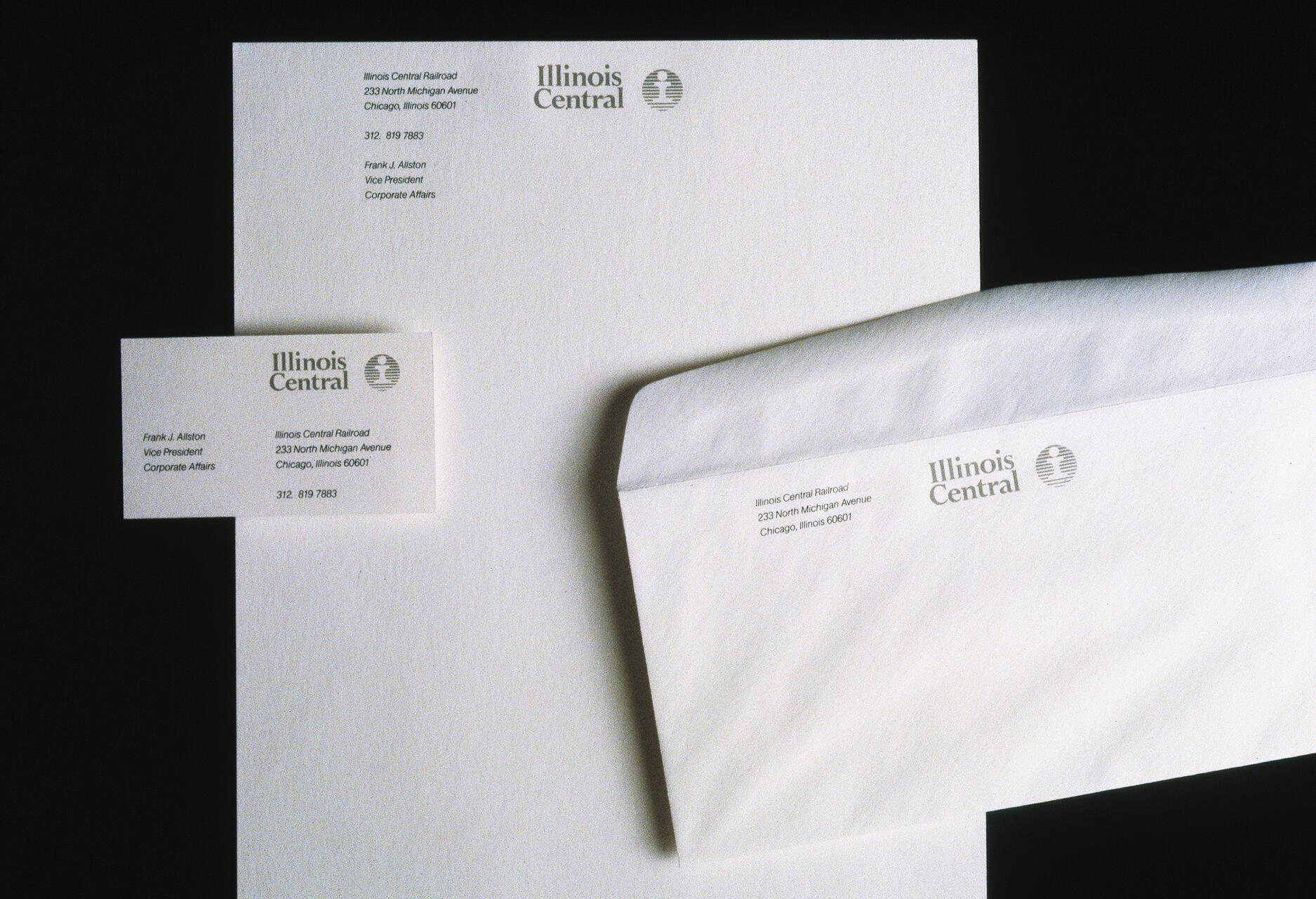 Stationery set on a black background, including a business card, letterhead, and envelope branded with "Illinois Central" logo and contact information.