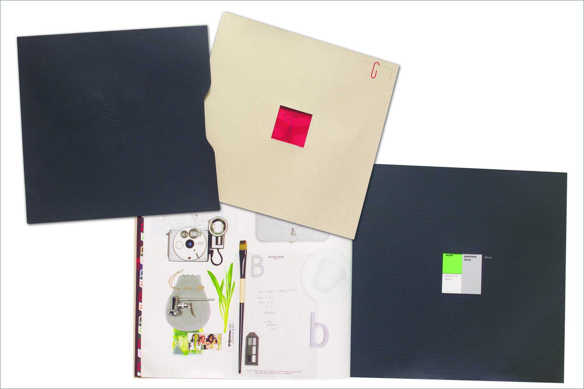 Three open folders with a beige one featuring a small pink cutout, and two dark blue ones. The bottom folder displays various artistic drawings and tools like a brush and color palette.