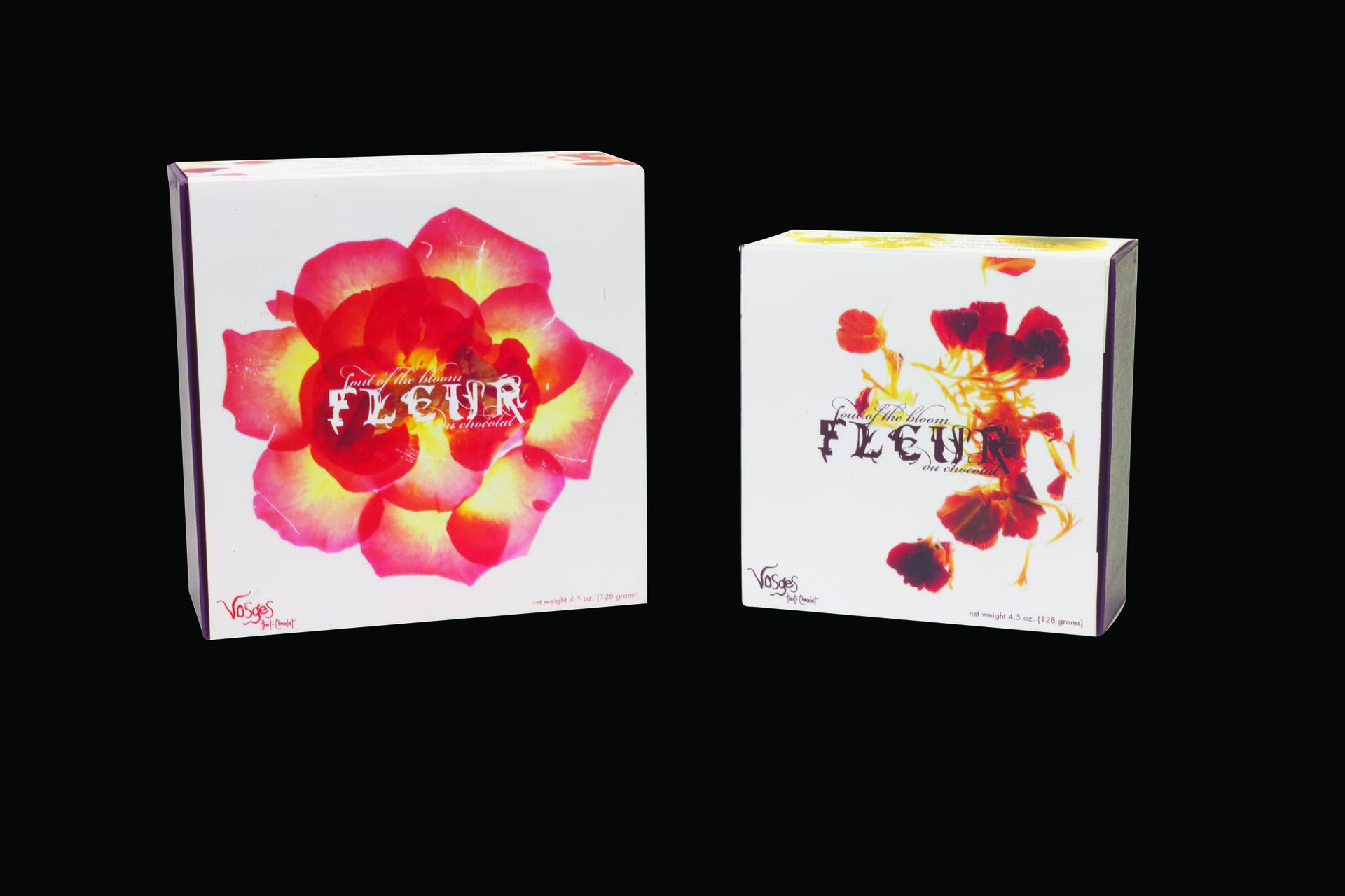 Two boxes with floral designs on a black background. The box on the left features a large, vibrant flower in shades of red and yellow. The box on the right displays smaller, red flowers. Both boxes have a similar artistic style and fonts.