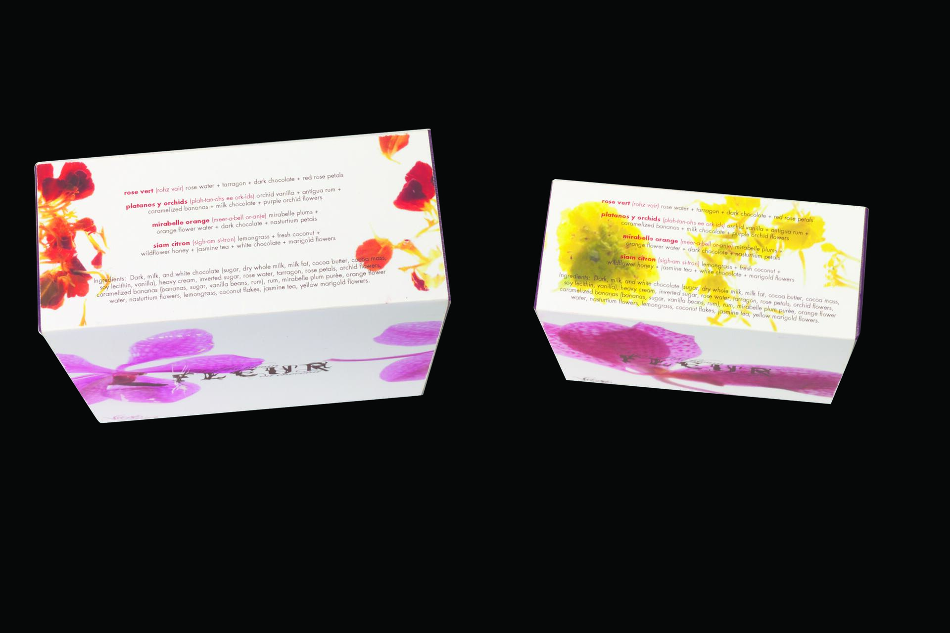 Two product boxes with floral designs in vibrant red, yellow, and purple hues. The left box features red and purple flowers, while the right has yellow and purple flowers. Text describing contents is visible on each box against a white background.