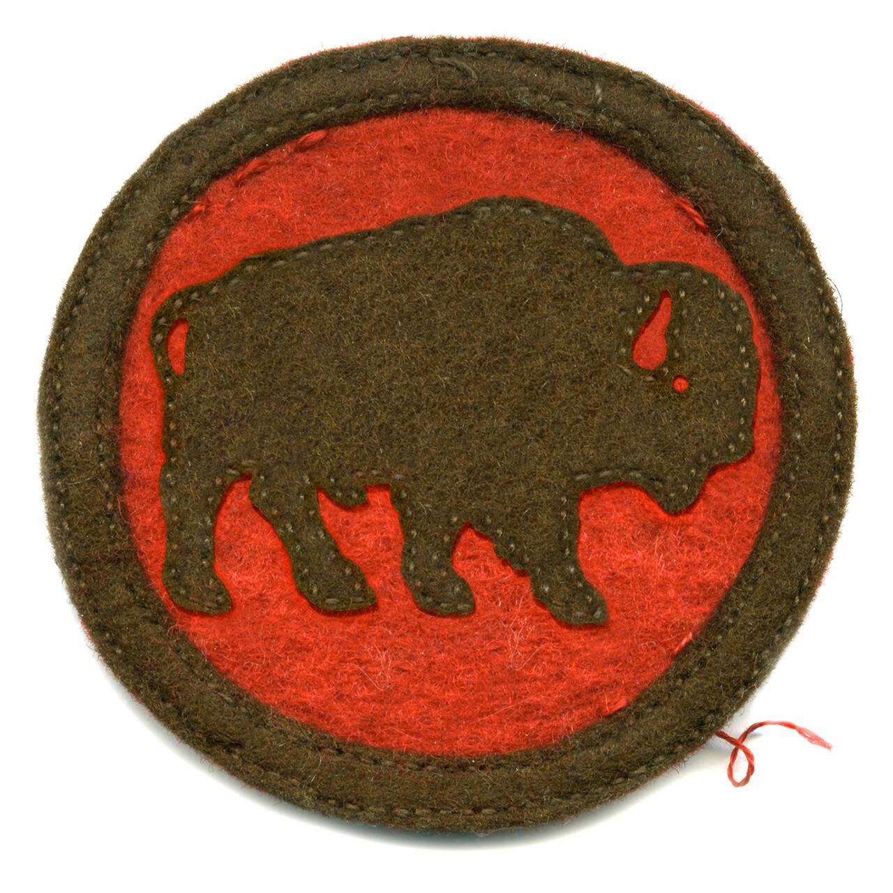 Brown bison silhouette on a red circular felt patch, bordered with a brown edge.