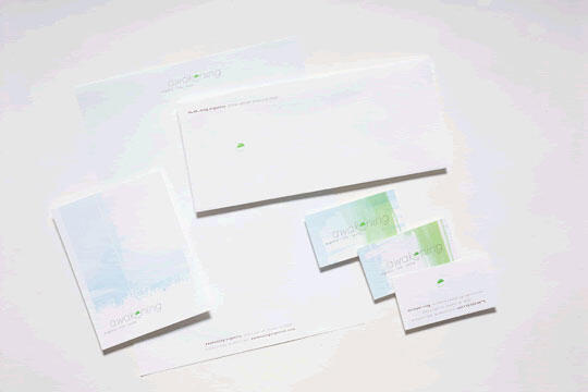 Stationery set with a minimalist design featuring envelopes, letterhead, and business cards in white and pastel hues.