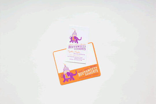 Business card and postcard with a purple elephant logo and "Bucy's Sweets & Desserts" text in orange and purple, on a white background.