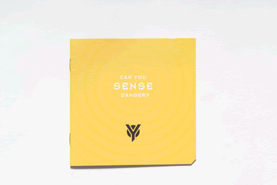 Yellow square graphic with text "CAN YOU SENSE DANGER?" and a stylized black logo resembling two leaves near the bottom, on a textured background.