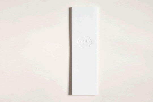 Rectangular white bookmark on a light background, embossed with the GAIA NYC logo at the top center.