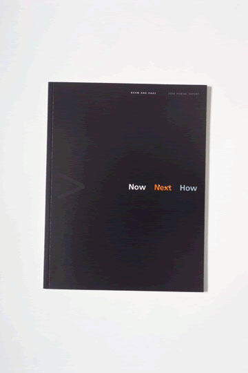 Black cover of an annual report with the words "Now Next How" in the center.