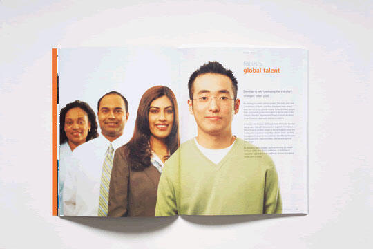 Four people stand in a line, smiling and facing forward, each dressed in professional attire. The background is light and the page on the right includes text titled "focus: global talent."