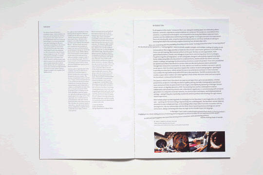 Open magazine spread with dense text on both pages. Bottom of the right page features a small photo of mechanical parts. Pages have a clean, white background.
