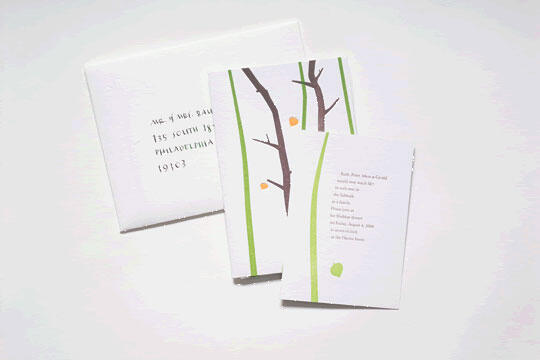 Two greeting cards with a minimalist design featuring tree branches and green stripes. One card is open, displaying text, while the other appears behind, partially obscured. The background is a subtle white, enhancing the card's colors.