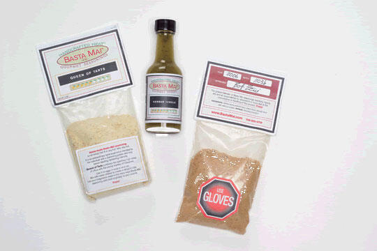 Packages of spice blends and a bottle of sauce on a white background. The left package is labeled "Queen of Tarts," the middle bottle is labeled "Herbal Finale," and the right package has a warning label "Use Gloves."