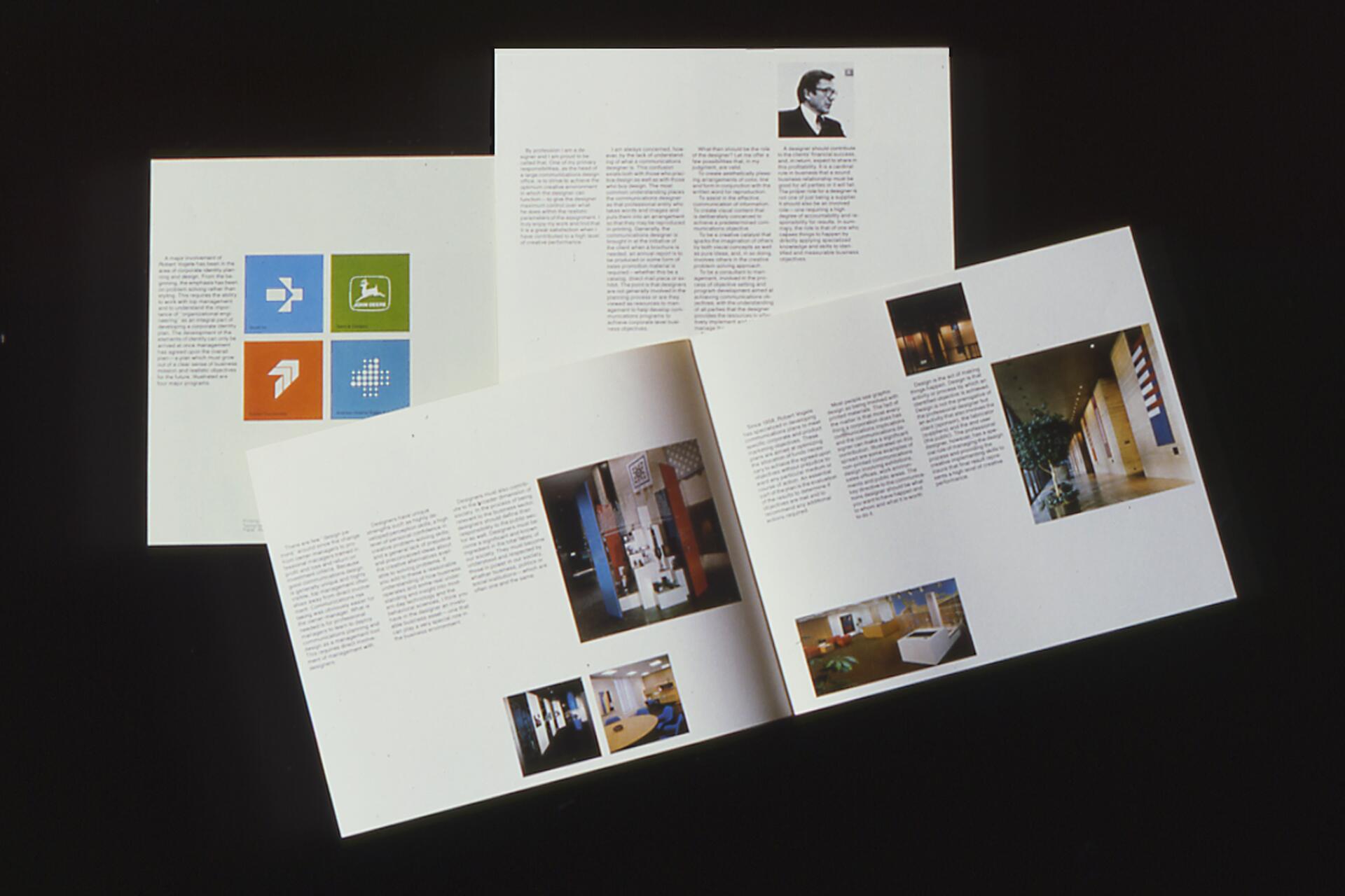 Three open brochures on a dark surface. The brochures feature various text blocks, photographs, and colorful square logos.