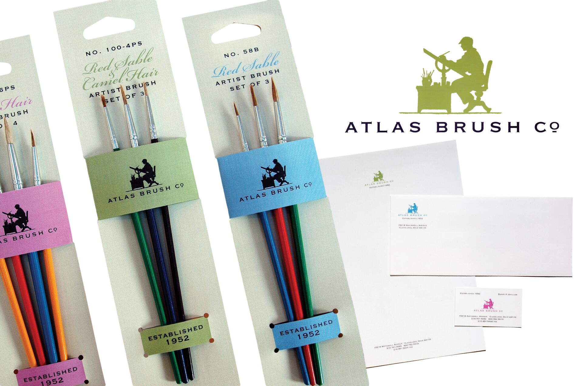 Paintbrush sets with colorful handles in packaging, alongside Atlas Brush Co. logo featuring a silhouette of a person with an easel. Business stationery with matching logos is displayed to the right.