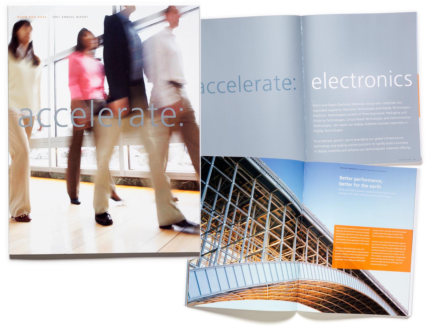 Blurry image of people walking past windows in a sunlit office; adjacent open magazine with text about electronics, showing a steel structure under a bright blue sky.