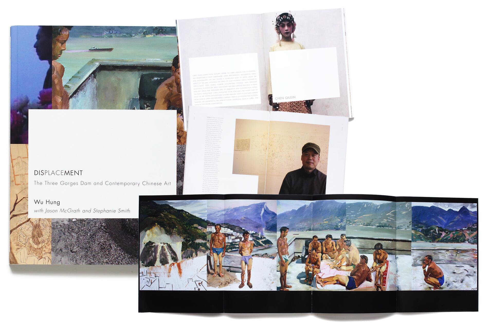 Open books and a spread featuring artwork and photographs relating to the Three Gorges Dam in China. The cover shows "Displacement" by Wu Hung. Inside, there's a portrait of a person wearing a cap and another figure in a yellow outfit. The foldout depicts people near a scenic river.
