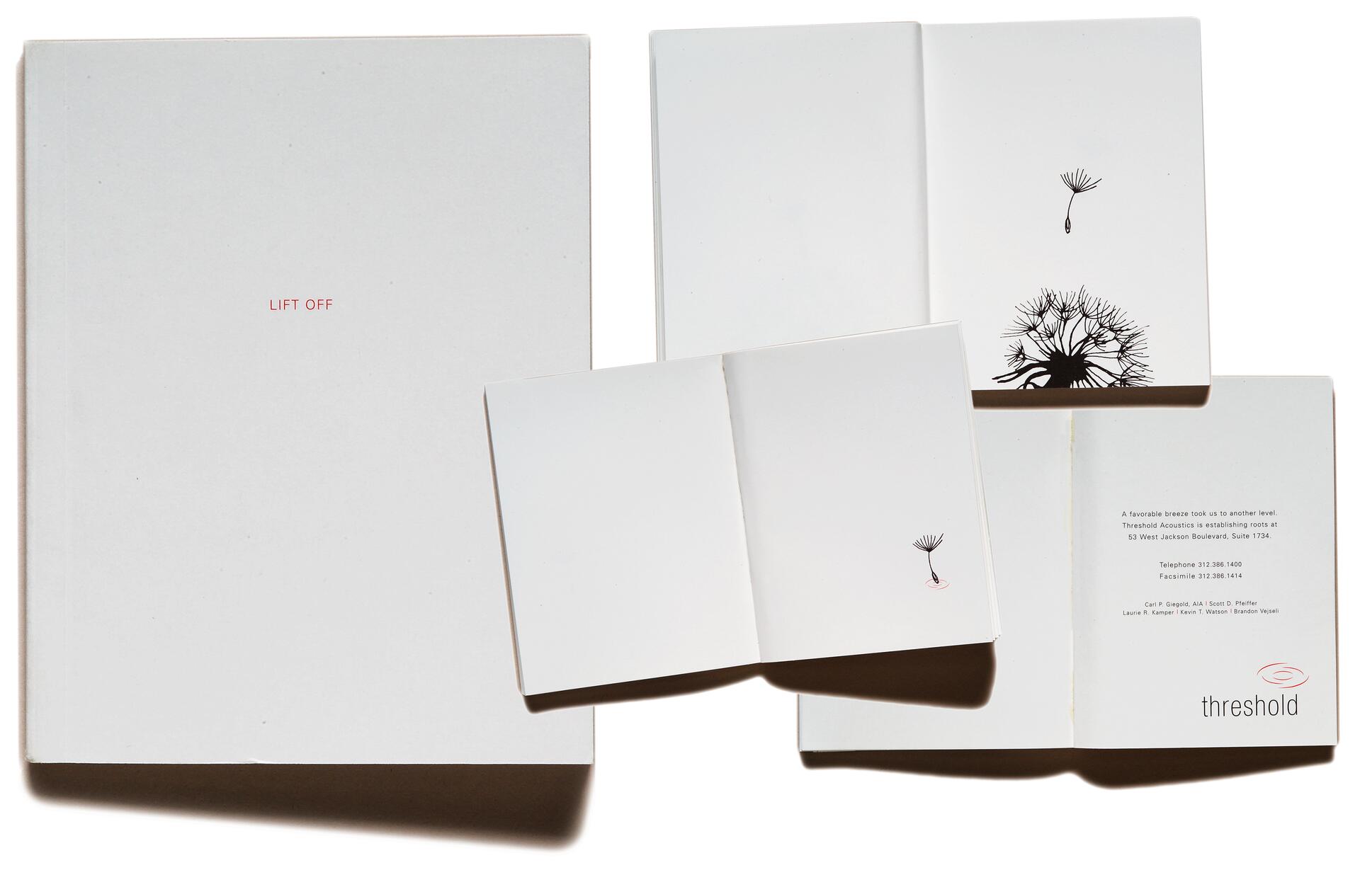 White book cover with red text "LIFT OFF," and open pages showing minimal black illustrations of a dandelion and seed. Inside, printed text includes contact information and the logo "Threshold" with a stylized eye design.