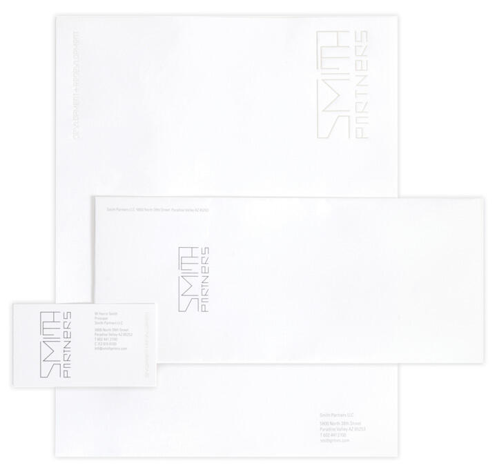 Stationery set featuring letterhead, envelope, and business card with "Smith Partners" logo in minimalistic design on white background.