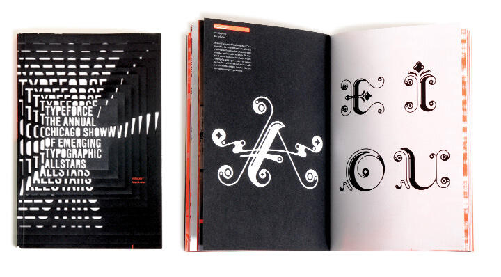 A book with a black cover featuring layered text. Inside, two open pages display ornate, curly black letters "A" on the left page and "E," "Ì," "O," "U" on the right, set against a white background.