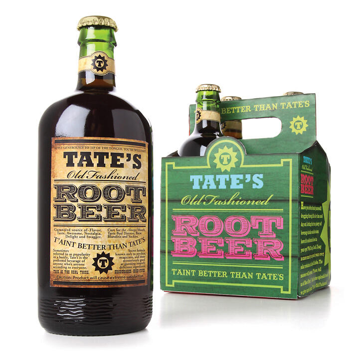 A bottle of Tate's Old Fashioned Root Beer next to a pack of four bottles. The bottle has a vintage-style label, and the pack features colorful graphics with the same branding.