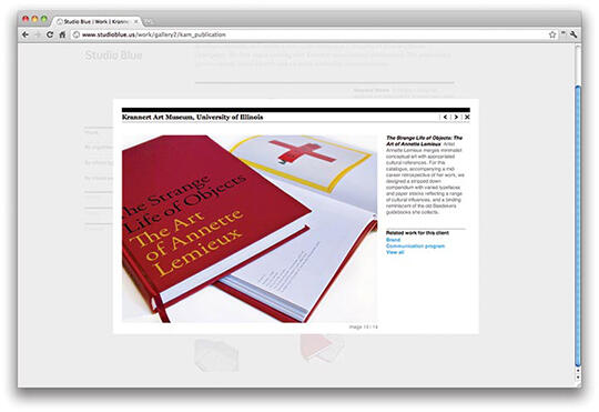 A webpage displaying a book titled "The Strange Life of Objects: The Art of Annette Lemieux" with a red cover. The book is opened to a page featuring a red cross illustration. The setting is an online gallery.