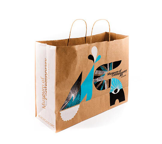 Brown paper bag with artistic geometric design in blue, black, and white, featuring the text "Museum of Contemporary Art" and two string handles.