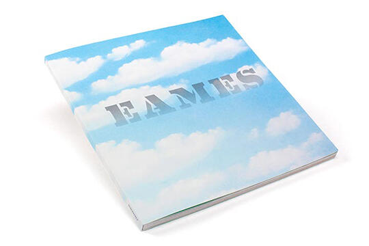 A book with a cover featuring a blue sky and white clouds, with the word "EAMES" in large uppercase letters.