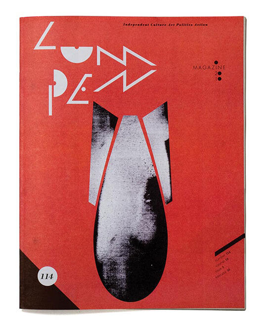 Red magazine cover featuring abstract black and white shapes resembling a stylized bomb, with angular white text at the top.
