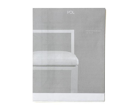 Minimalist magazine cover with a monochrome color scheme featuring part of a modern chair and clean lines. The title "VOL" is centered at the top.