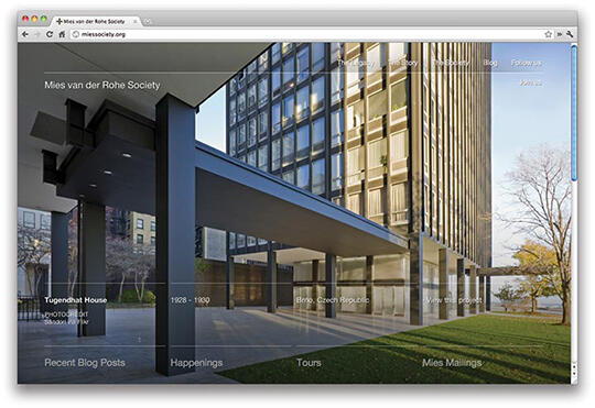 A web page displaying a modern architectural building with tall windows and an overhanging roof, set in an urban environment. The background shows trees and a clear blue sky.
