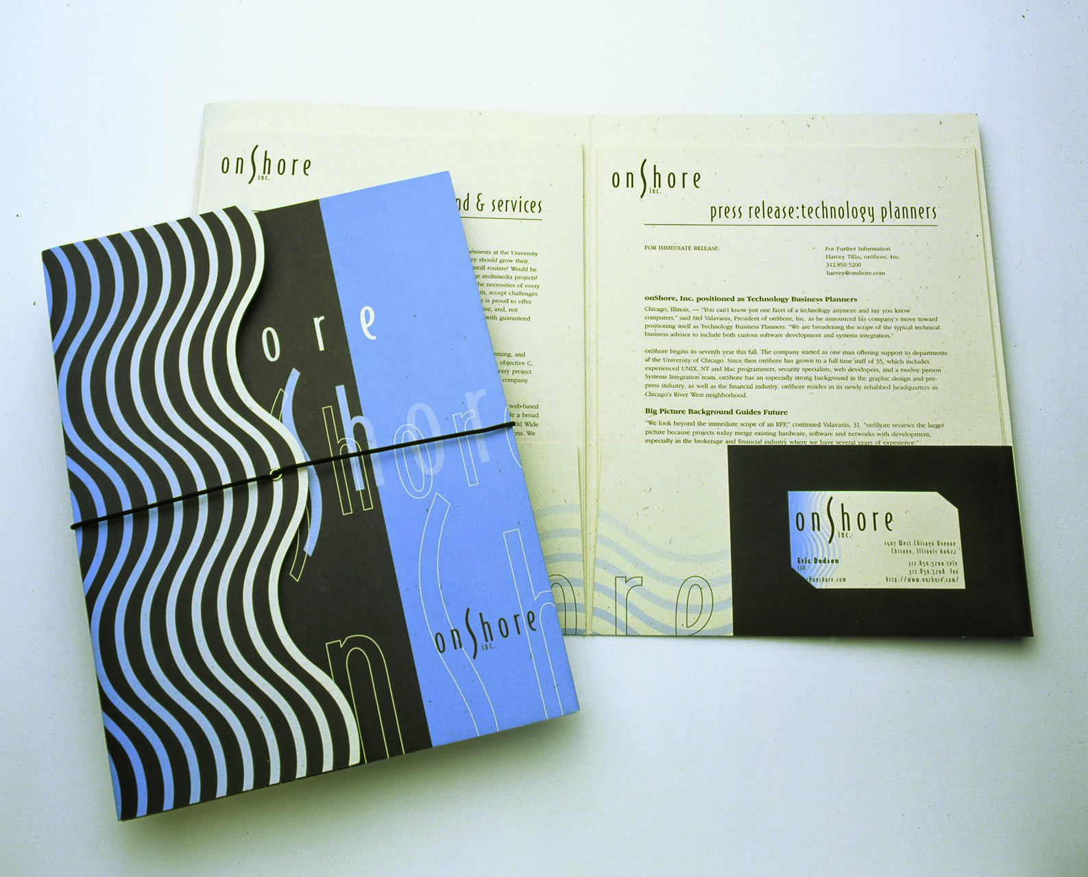 Promotional materials for "onShore inc." featuring a blue and black patterned folder, a press release document, and a business card. The design includes wavy lines and modern typography.