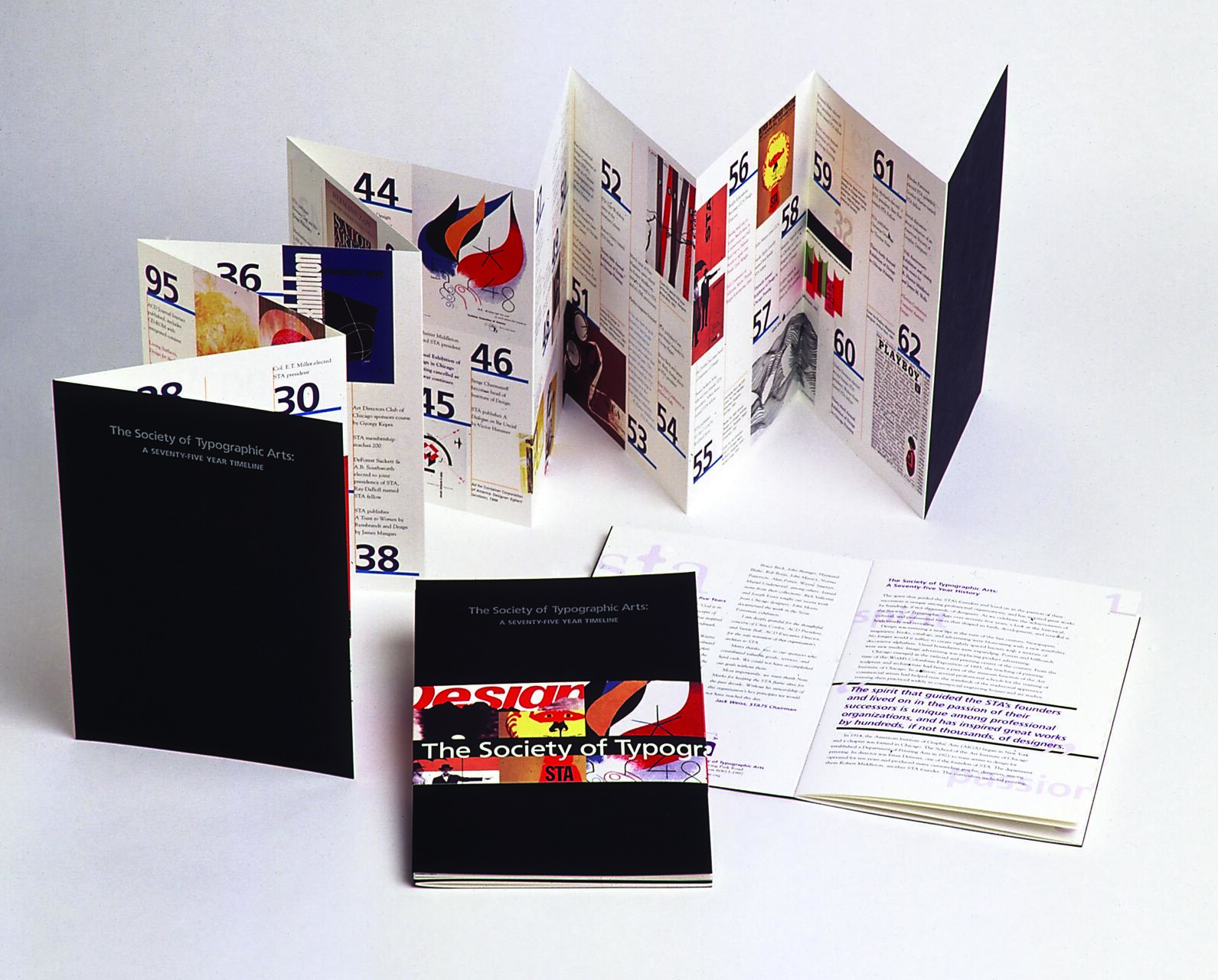 Folded brochures and booklets titled "The Society of Typographic Arts: A Seventy-Five Year Timeline" with colorful graphic designs and text.