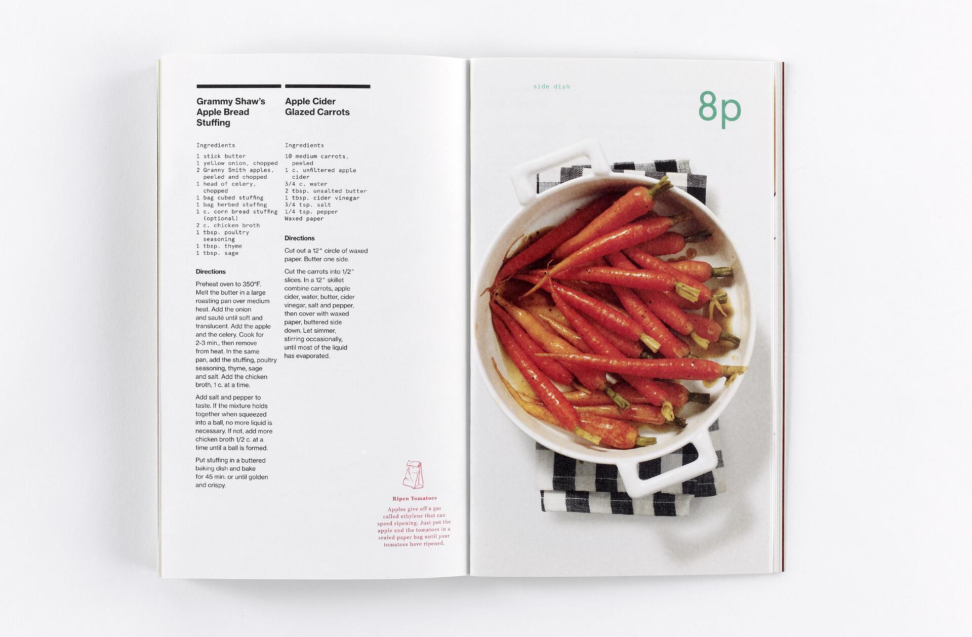 Open cookbook with recipes for Apple Bread Stuffing and Apple Cider Glazed Carrots. On the right page, a photo shows glazed carrots in a white dish, resting on a checkered cloth.
