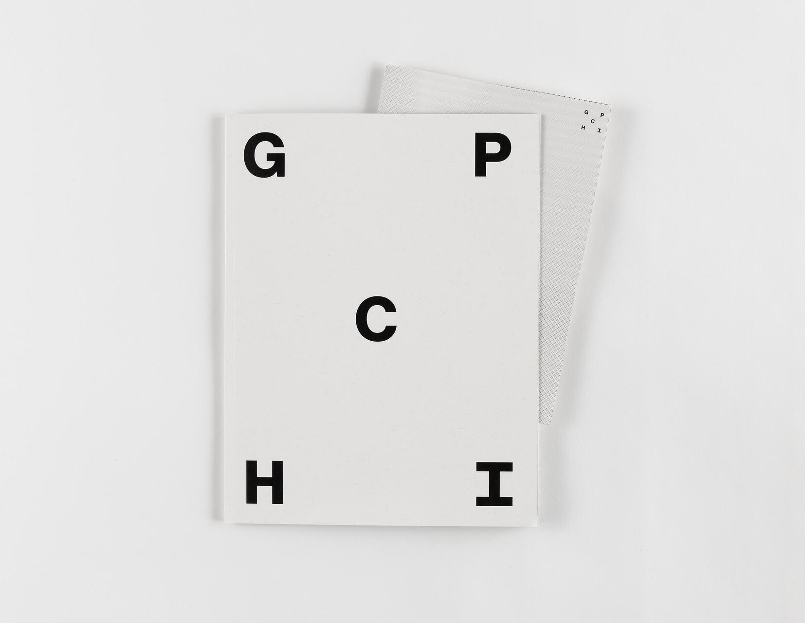 White notebook with black capital letters G, C, H, I, and P on the cover. Positioned on top of a gray dotted sheet.