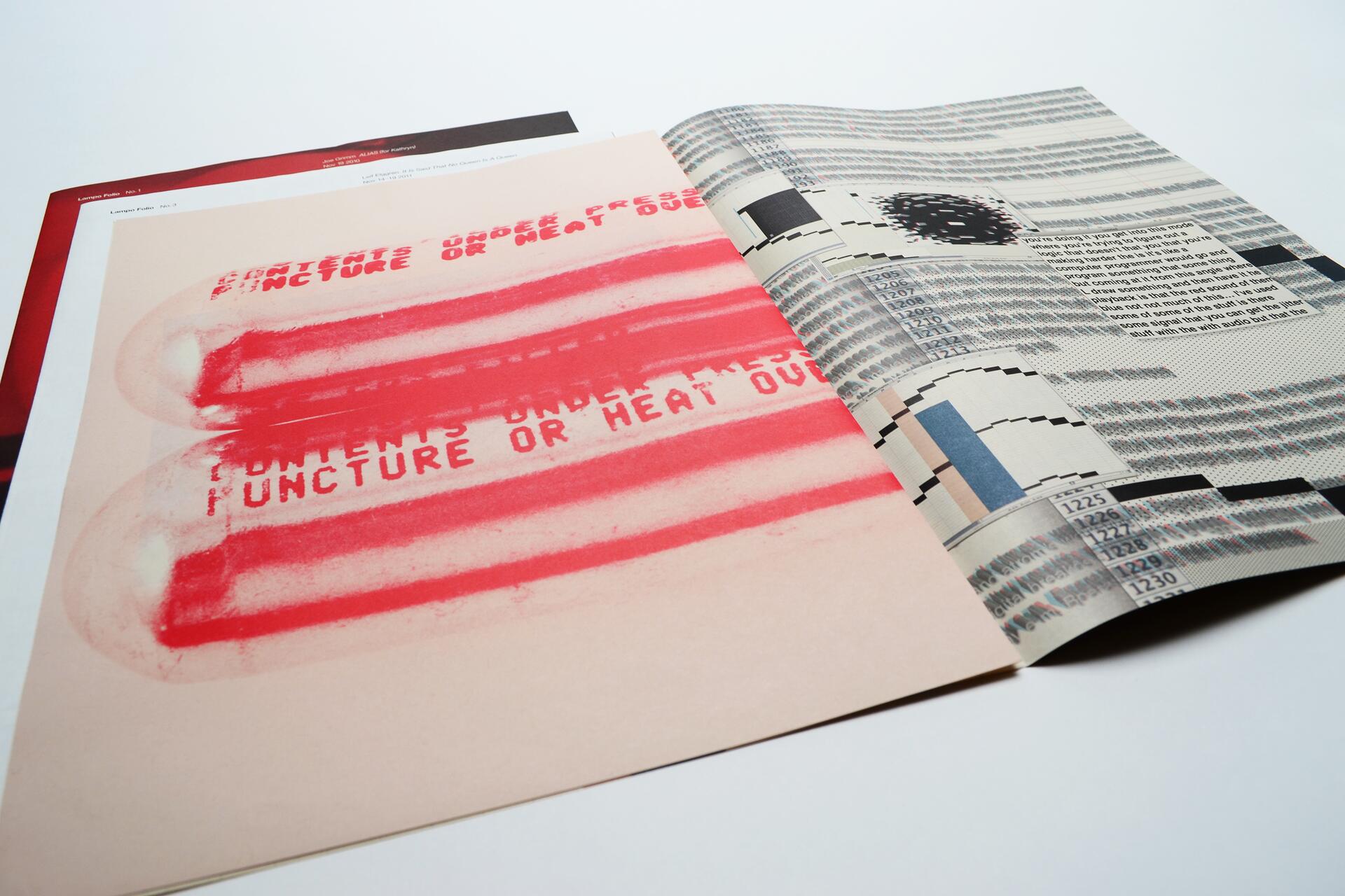 Open magazine showing abstract red and beige graphics on the left page and text with black and gray patterns on the right page, placed on a white surface.