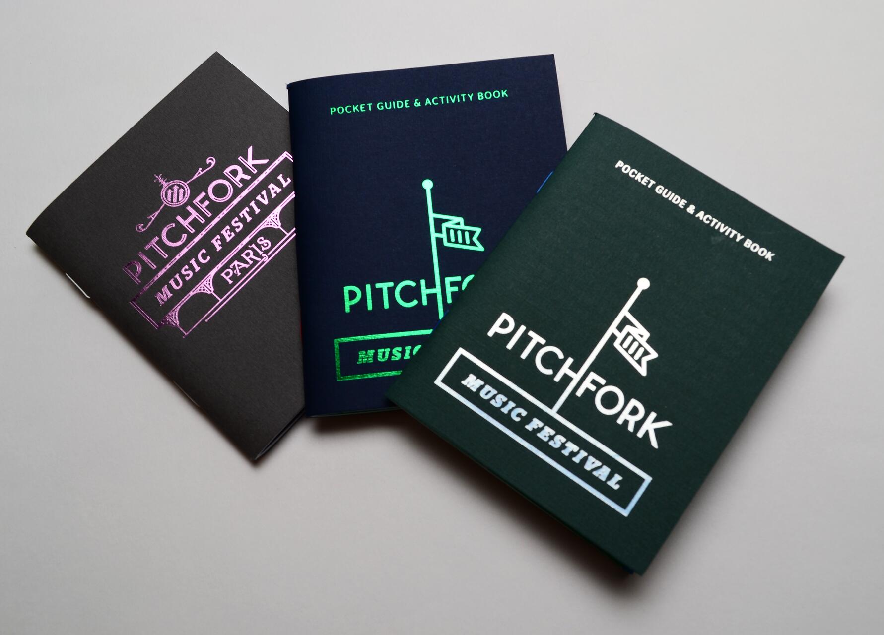 Three Pitchfork Music Festival pocket guides with different cover designs and colors, including black, blue, and green.