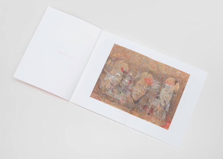 An open book displaying abstract art with earthy tones and overlapping faces on the right page; the left page is mostly blank.