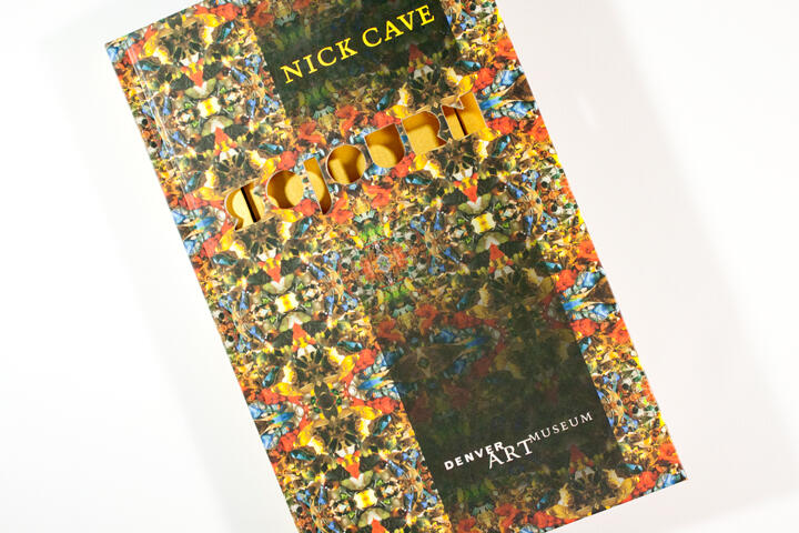 Book cover with a kaleidoscopic pattern of vibrant autumn leaves in reds, oranges, yellows, and blues. The title "Nick Cave" and "Denver Art Museum" are visible, with "Sound" integrated into the design.