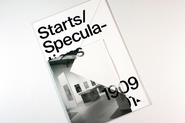 A modern art exhibit poster with bold black text partially covering a black and white photo of a gallery interior, displaying framed artworks on white walls.