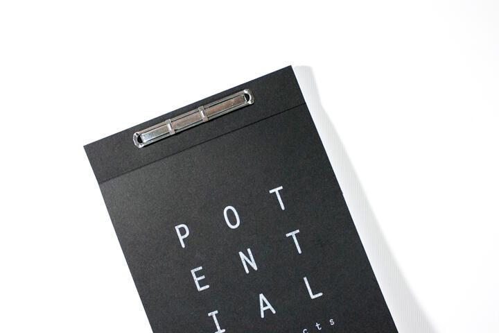 Black clipboard with "POTENTIAL" written vertically in white letters, and a metal clip on top.