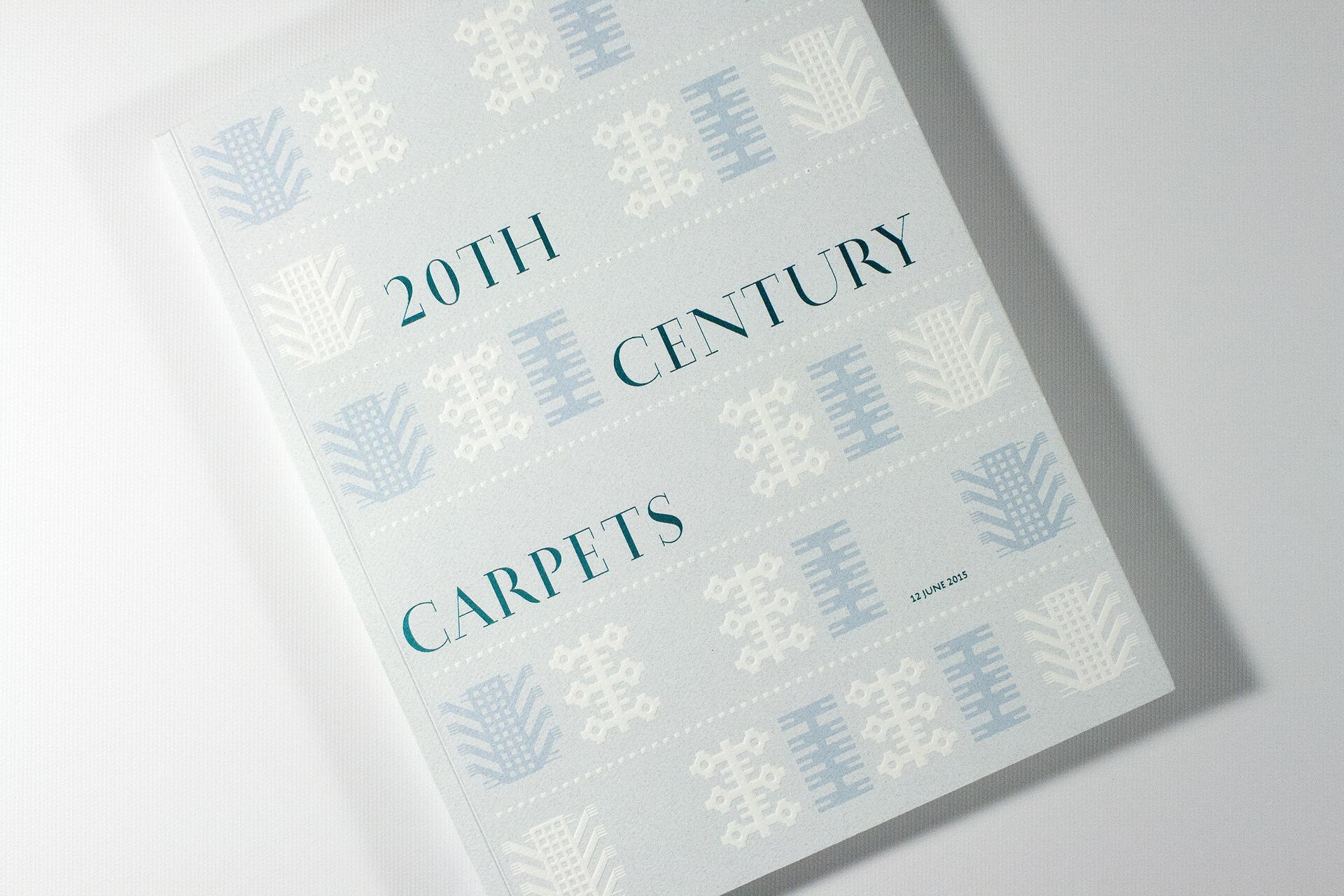 Book titled "20th Century Carpets" with light blue and white geometric patterns on the cover.