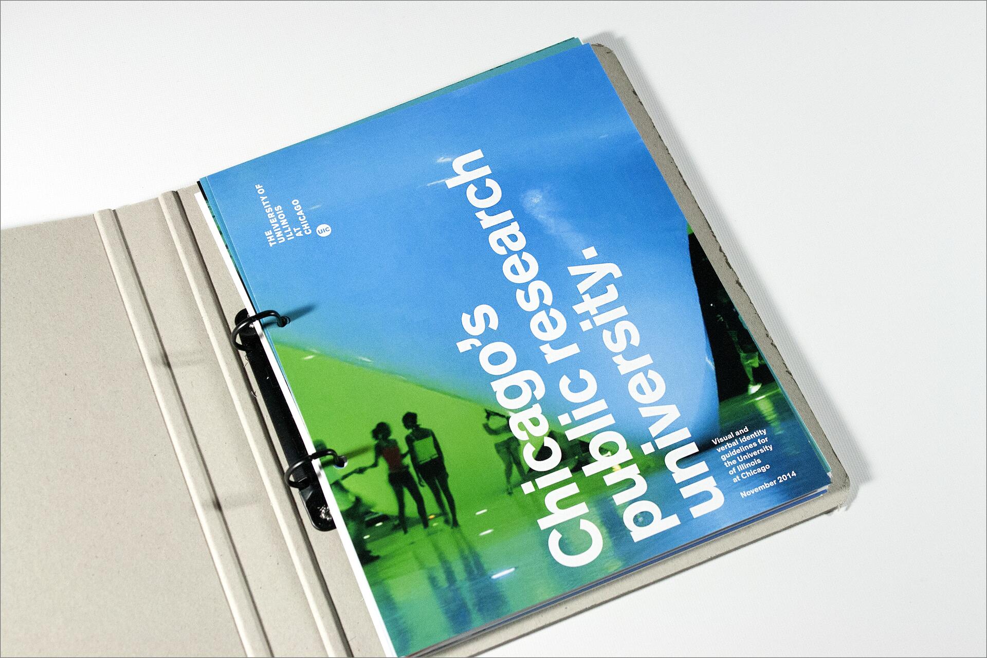 Blue and green cover of a university guidebook in a binder, titled “Chicago’s public research university.”
