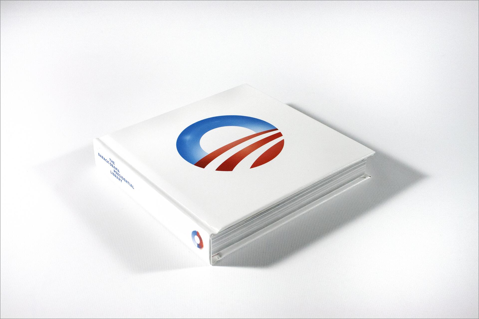 White book with a stylized "O" logo in blue and red on the cover.