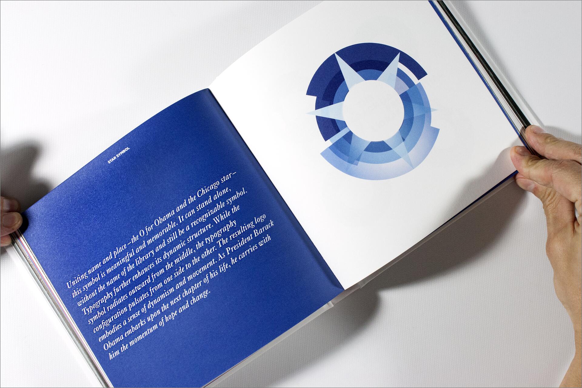 Open book showing blue text on the left page and a circular blue geometric symbol on the right, with hands holding the pages.