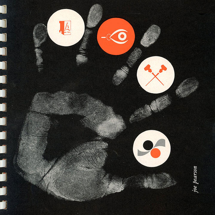 Black background with a white handprint. Four circular icons in red and white are placed on the fingertips and palm. Icons include an eye, two hammers crossed, abstract shapes, and stylized letters. A spiral notebook edge is visible on the left.
