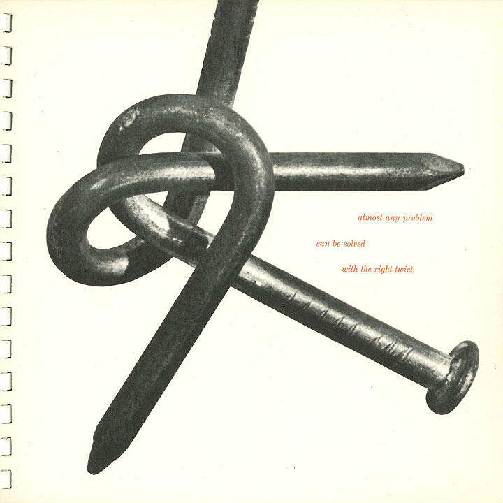 Three large nails intertwined in a knot, on a light background.