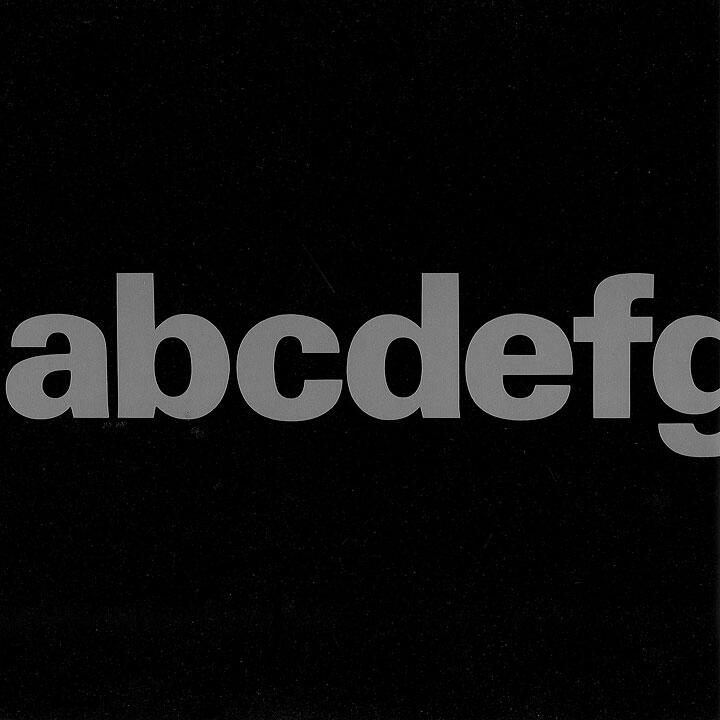 Lowercase gray letters "abcdefg" on a black background.