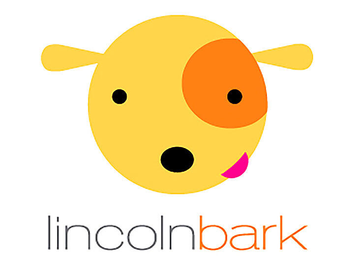Yellow, cartoon-like dog face with an orange spot over one eye, a pink tongue sticking out, and a simple black nose. The text "lincolnbark" appears below, with "bark" in orange.