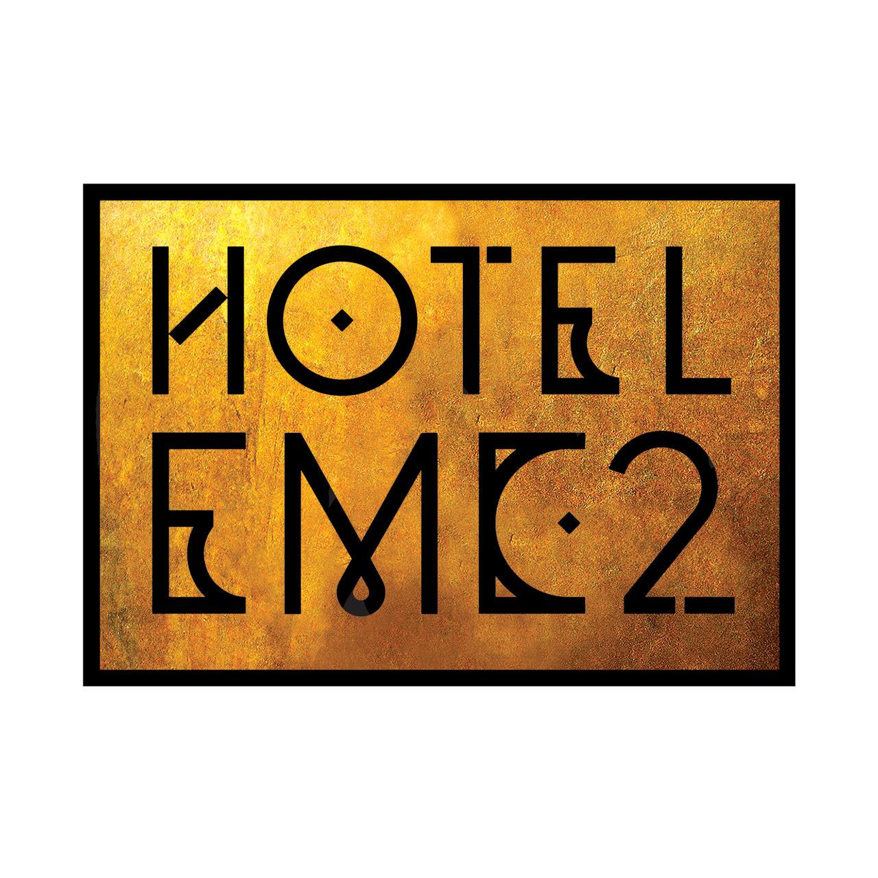 Hotel EMC2 logo with bold black lettering on a textured gold background.