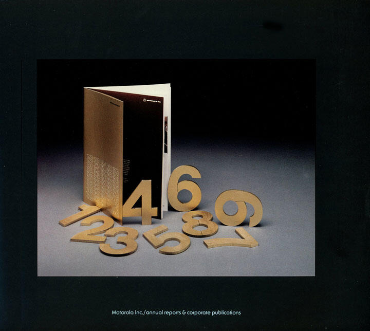 Open booklet with gold numeric cutouts scattered in front, featuring numbers 1-9, against a dark gradient background.