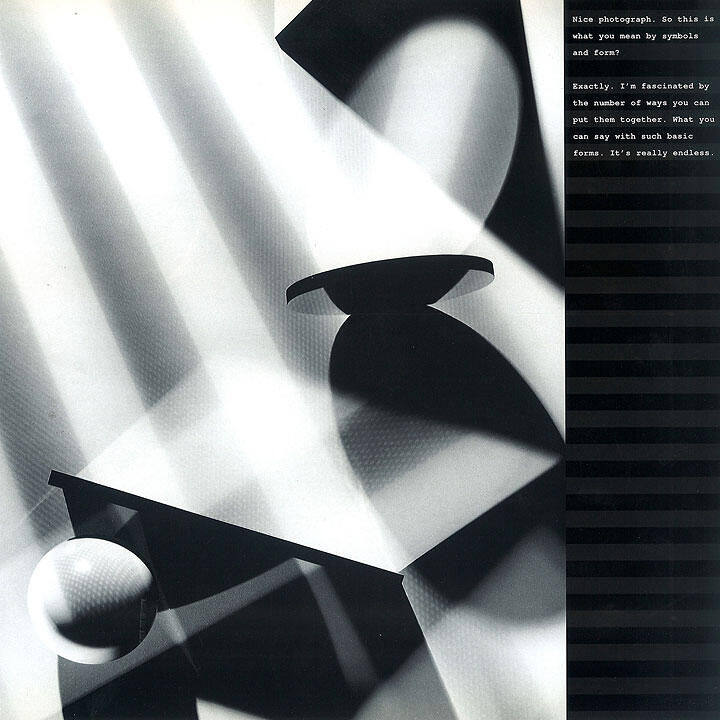 Black and white abstract photograph with geometric shapes casting shadows, including a sphere and angled surfaces, creating a play of light and shadow. Vertical striped pattern on the right side.